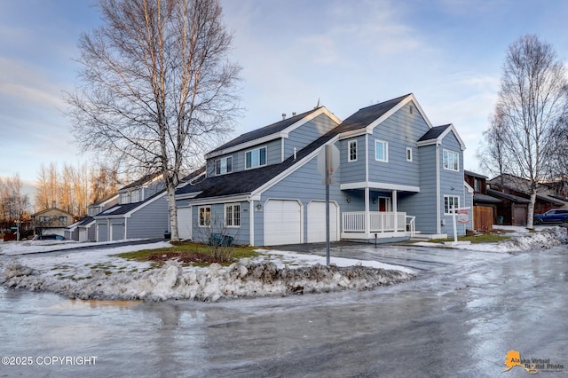 front facade featuring covered porch and a garage