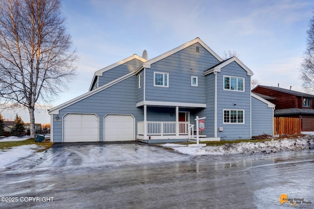 view of front of property featuring covered porch and a garage