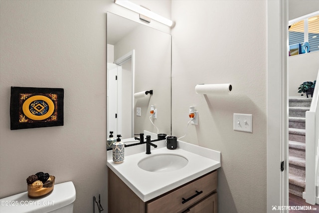 bathroom with toilet and vanity