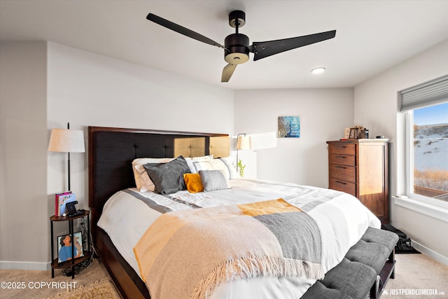 bedroom with ceiling fan and light carpet