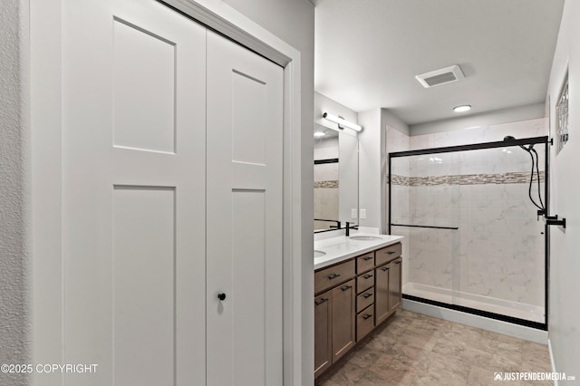 bathroom with walk in shower and vanity