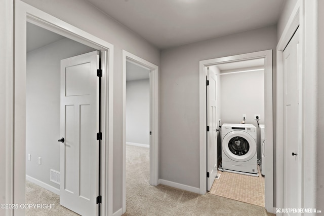 washroom featuring light colored carpet and washer / dryer