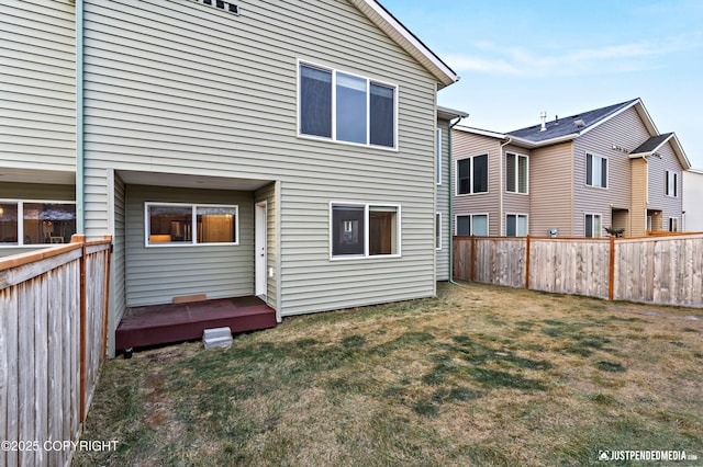 rear view of house featuring a lawn