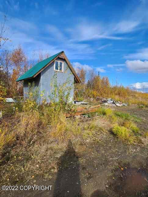 view of side of property with a shed