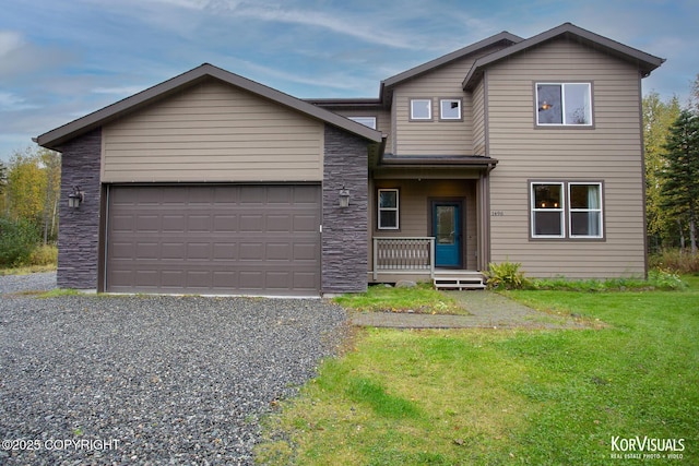 view of front of home featuring a front yard, a porch, and a garage