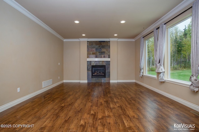 unfurnished living room with a tiled fireplace, a wealth of natural light, and dark hardwood / wood-style floors