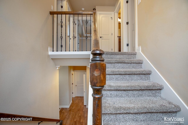 stairway featuring hardwood / wood-style floors