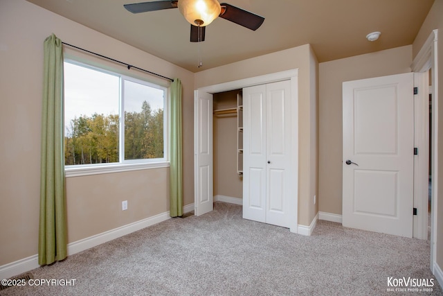 unfurnished bedroom with ceiling fan, light carpet, and a closet