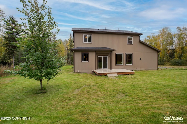 back of property featuring a deck and a yard