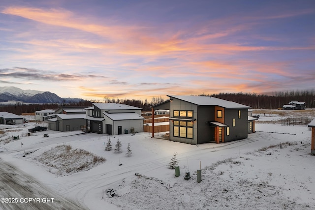 snow covered house featuring a mountain view