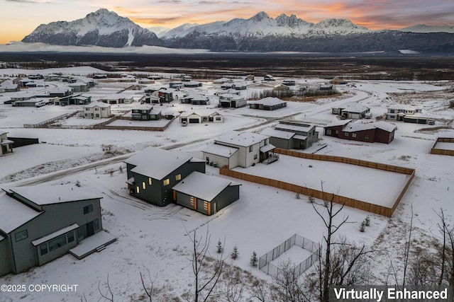 snowy aerial view with a mountain view