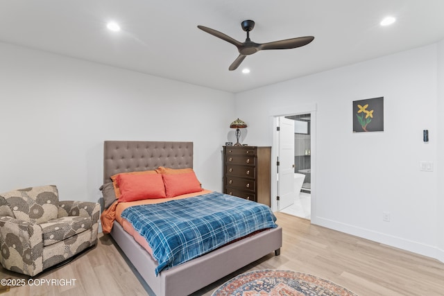 bedroom with hardwood / wood-style flooring, ceiling fan, and ensuite bath