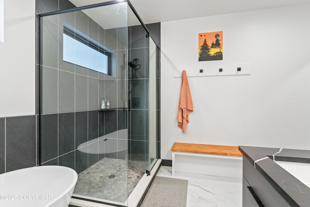 bathroom featuring vanity and shower with separate bathtub