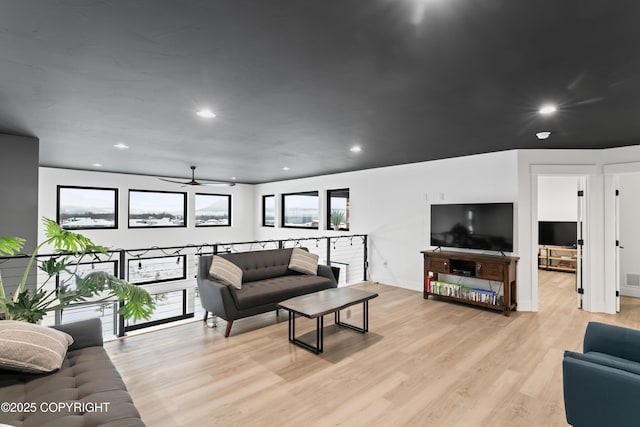 living room with light wood-type flooring and ceiling fan