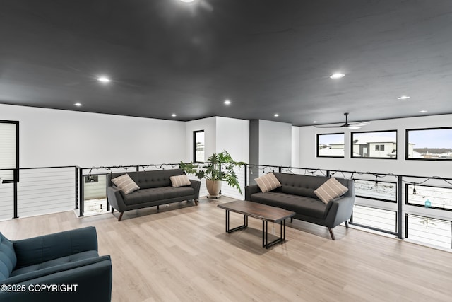 living room featuring light wood-type flooring and ceiling fan