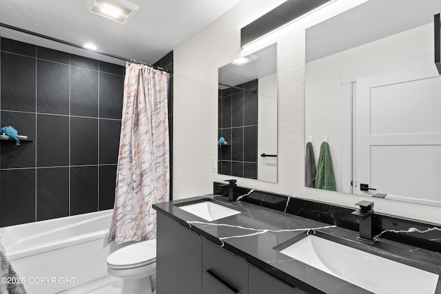 full bathroom featuring shower / bath combination with curtain, vanity, and toilet