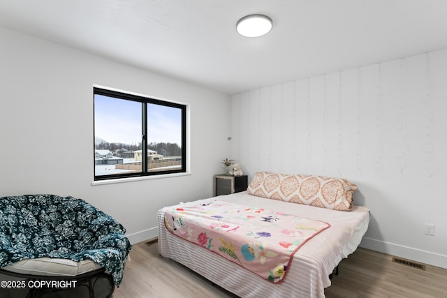 bedroom with light hardwood / wood-style floors