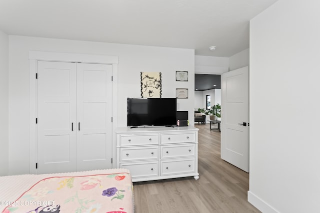 bedroom with a closet and light wood-type flooring