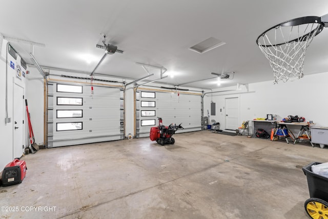 garage with a garage door opener and electric panel