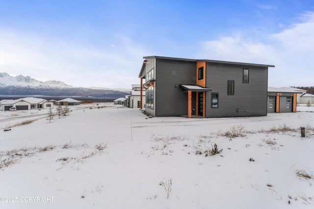 snow covered house with a mountain view