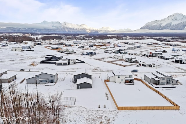 snowy aerial view featuring a mountain view