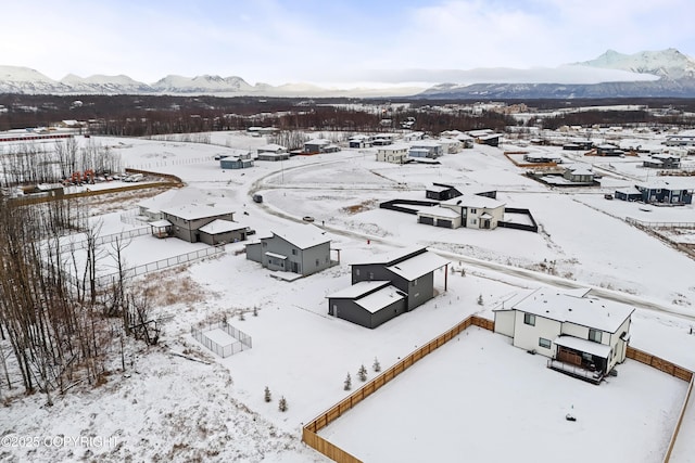 snowy aerial view featuring a mountain view