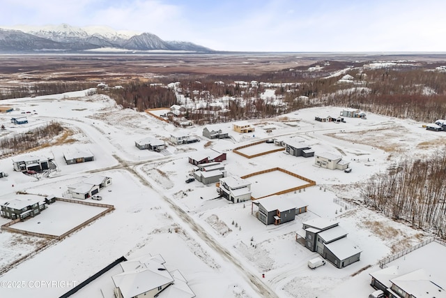 snowy aerial view featuring a mountain view