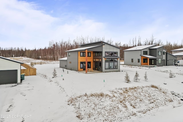 snow covered property featuring a garage