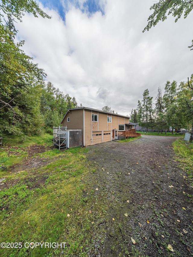 back of house with a wooden deck