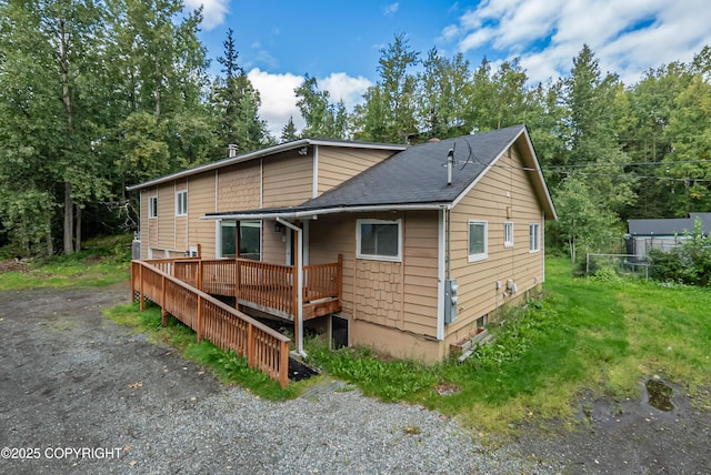 rear view of property featuring a deck