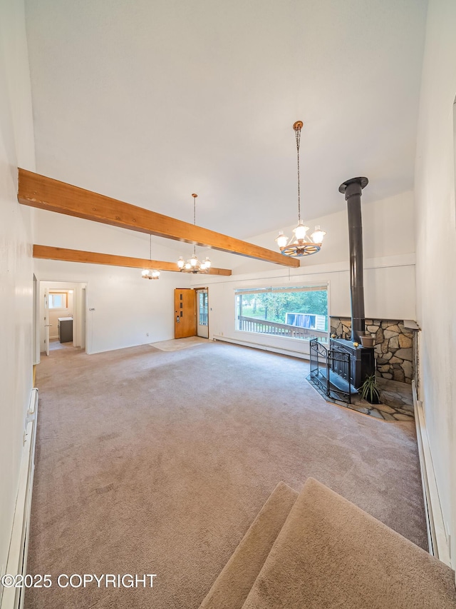 unfurnished living room with a wood stove, an inviting chandelier, beamed ceiling, a baseboard heating unit, and carpet floors