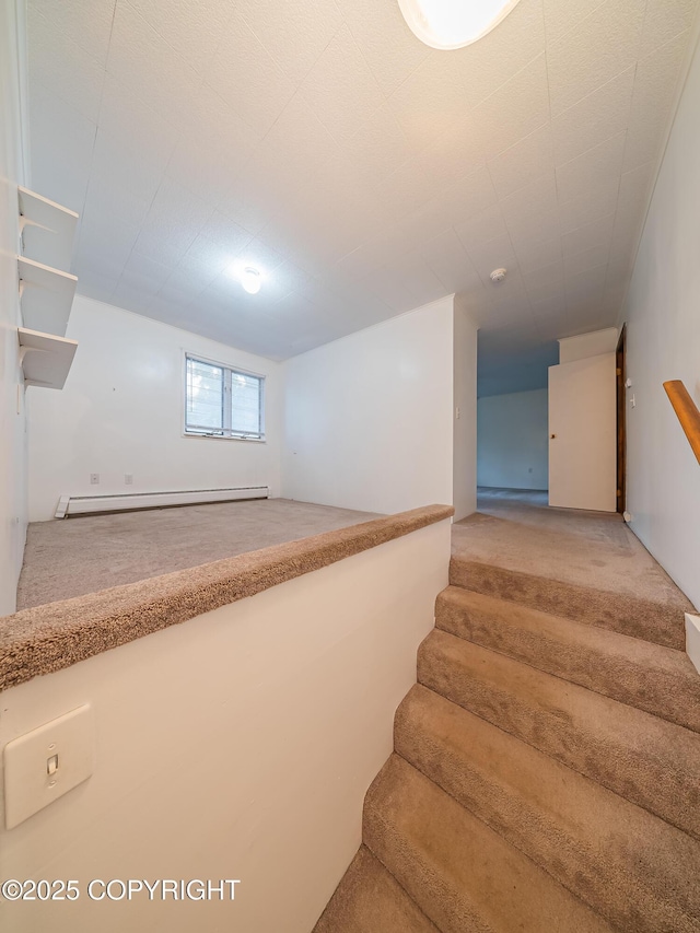 stairs with carpet floors and a baseboard radiator