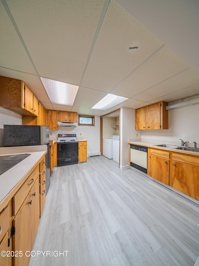 kitchen featuring dishwasher, range with electric stovetop, a drop ceiling, and washing machine and dryer