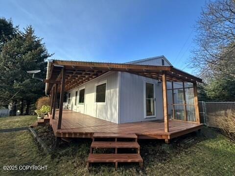 view of property exterior with a pergola, a deck, and a sunroom