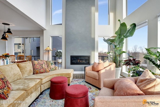 living room with a high ceiling and wood-type flooring