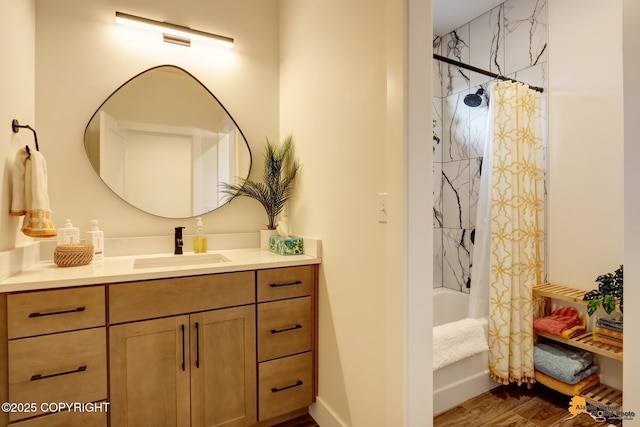 bathroom with wood-type flooring, vanity, and shower / bathtub combination with curtain