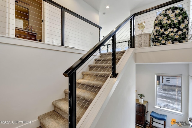 stairway featuring a high ceiling