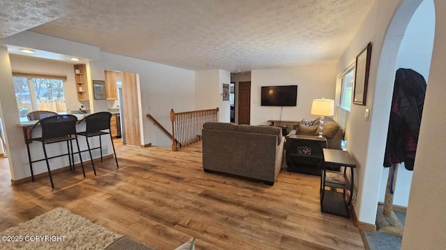 living room featuring a textured ceiling and hardwood / wood-style flooring