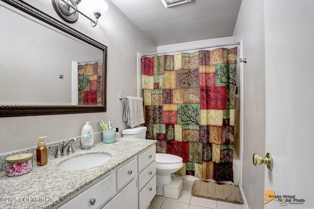 5450 E Alder Dr, Wasilla, AK 99654 - bathroom with vanity, toilet, tile patterned floors, a textured ceiling, and a shower with shower curtain