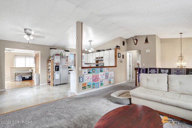 5450 E Alder Dr, Wasilla, AK 99654 - living area featuring lofted ceiling, light carpet, baseboards, ceiling fan with notable chandelier, and light tile patterned floors