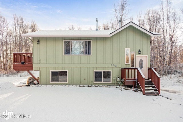 view of snow covered rear of property