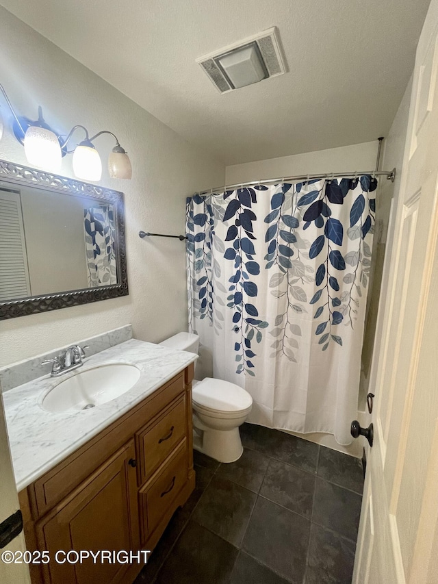 bathroom featuring a shower with curtain, vanity, tile patterned floors, and toilet