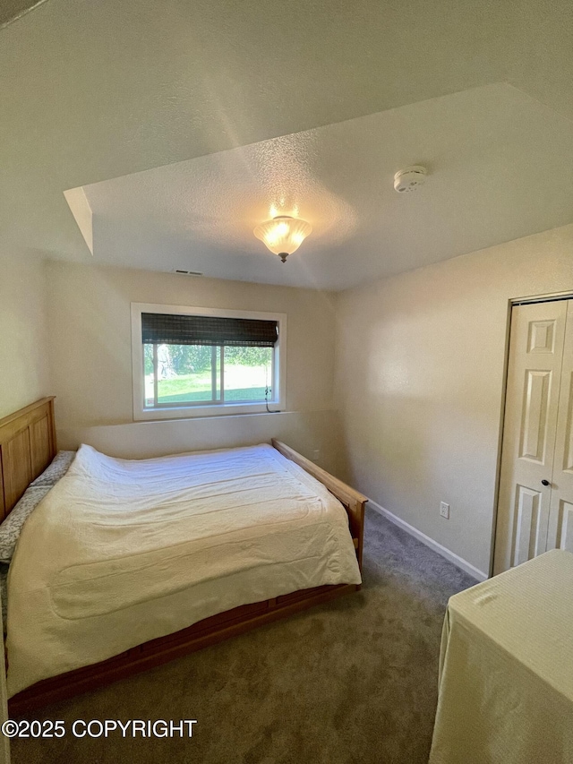 bedroom with dark colored carpet