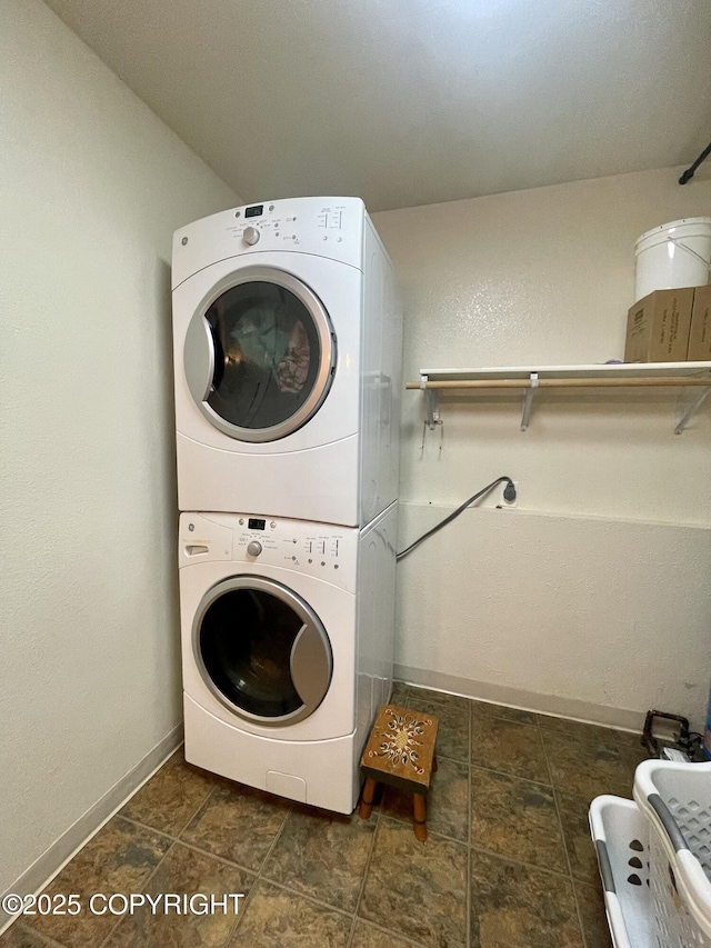 clothes washing area with stacked washer / drying machine