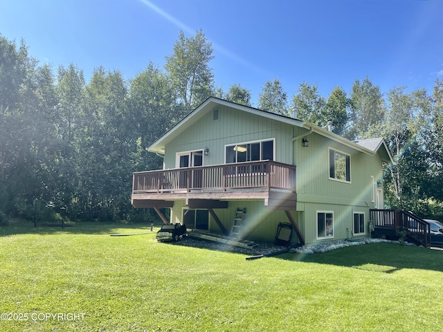 back of property featuring a wooden deck and a yard