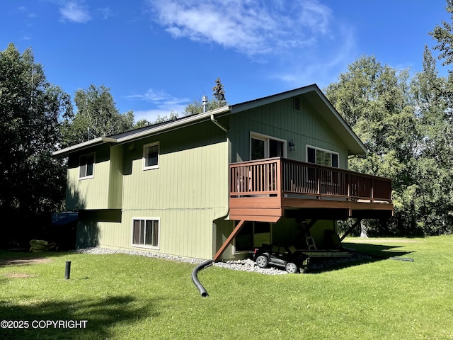 rear view of property featuring a wooden deck and a lawn