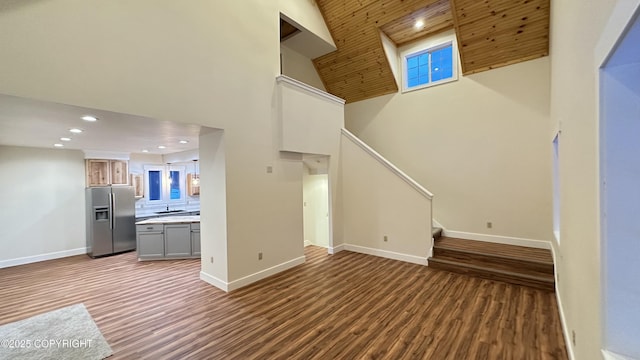 unfurnished living room featuring high vaulted ceiling, wood ceiling, and hardwood / wood-style floors