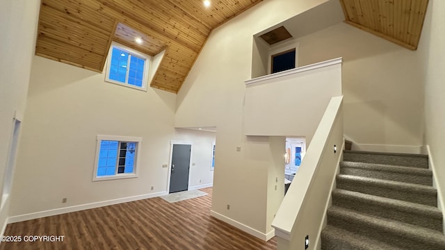 stairs with wood ceiling and a towering ceiling