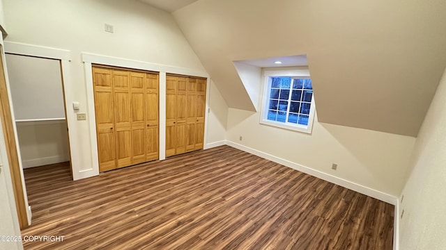 additional living space with dark wood-type flooring and vaulted ceiling