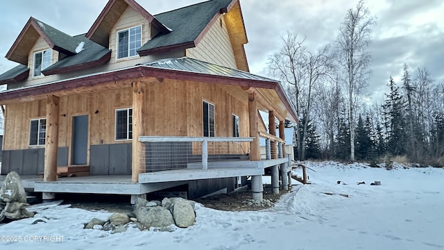 view of snow covered exterior featuring covered porch